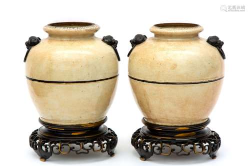 Two Nanking ware vases mounted on a brass base