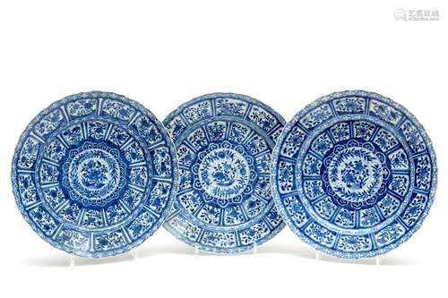 Three large blue and white plates