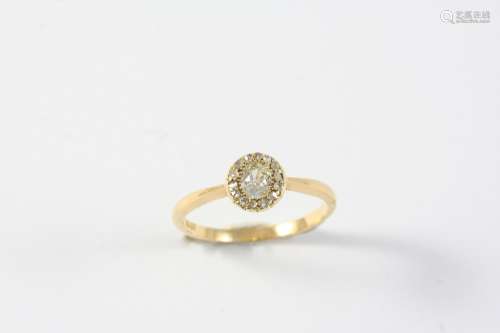 A DIAMOND CLUSTER RING the oval-shaped old cut diamond is se...