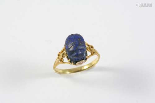 A LAPIS LAZULI SCARAB RING the gold mount and shank with rop...