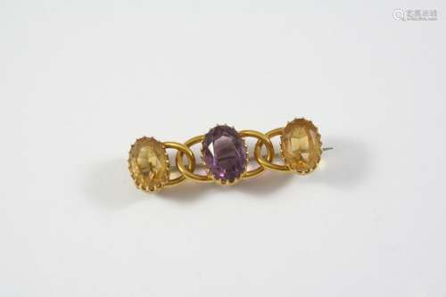 AN AMETHYST AND CITRINE BROOCH the oval-shaped amethyst is s...
