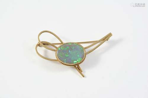 A BLACK OPAL AND GOLD BROOCH the oval-shaped solid black opa...