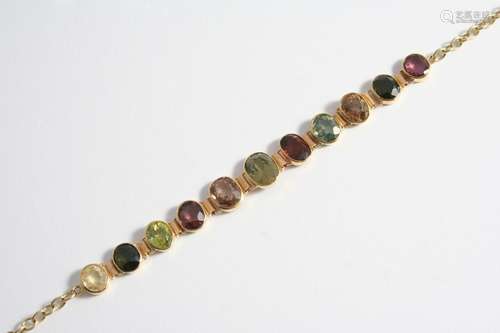 A GOLD AND GEM SET BRACELET the 18ct gold bracelet is mounte...