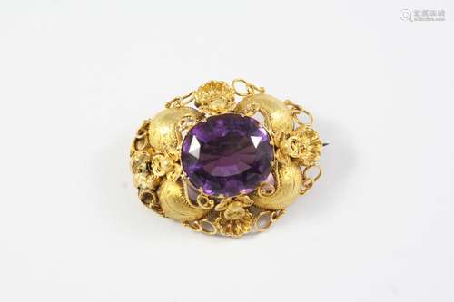 A VICTORIAN AMETHYST AND GOLD BROOCH the oval-shaped amethys...