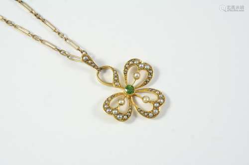 AN EDWARDIAN PERIDOT AND SEED PEARL PENDANT the openwork thr...