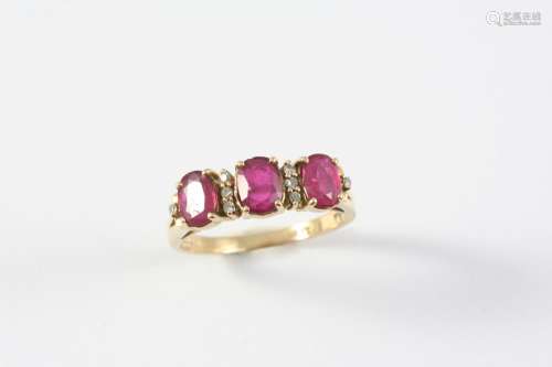 A RUBY AND DIAMOND RING the three oval-shaped rubies are set...