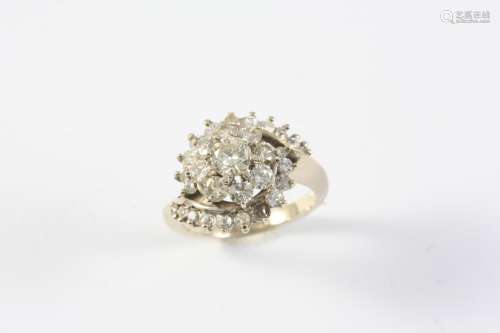 A DIAMOND CLUSTER RING the central circular-cut diamond is s...