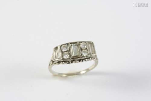 A DIAMOND RING set with three baguette-cut diamonds and four...