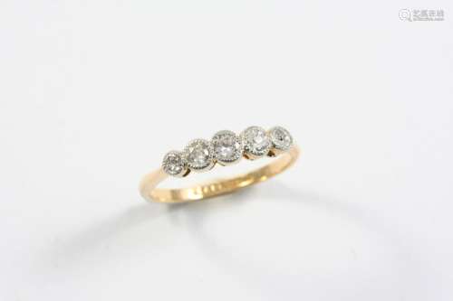 A DIAMOND FIVE STONE RING set with five collet set diamonds,...