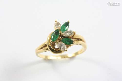 AN EMERALD AND DIAMOND RING set with three marquise-cut emer...