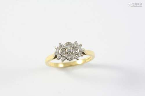 A DIAMOND CLUSTER RING mounted with graduated circular-cut d...
