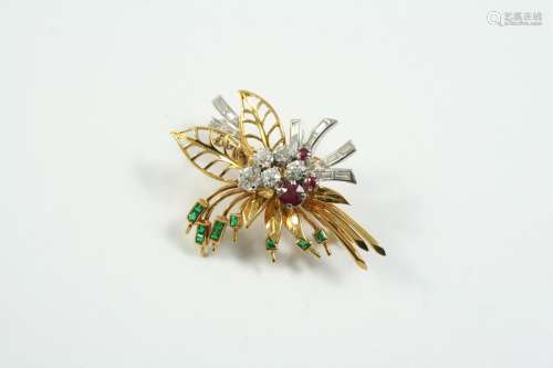 A RUBY, EMERALD AND DIAMOND FOLIATE SPRAY BROOCH mounted wit...