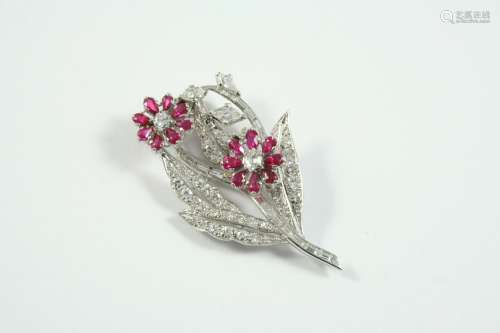 A RUBY AND DIAMOND FOLIATE SPRAY CLIP BROOCH formed with two...