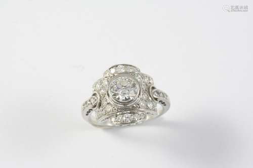 A DIAMOND CLUSTER RING the central circular-cut diamond is s...