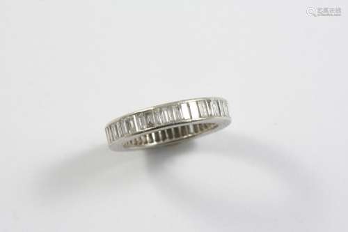 A DIAMOND FULL CIRCLE ETERNITY RING set with baguette-cut di...