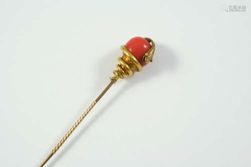 A CORAL AND GOLD SNAKE STICK PIN mounted with a coral bead e...