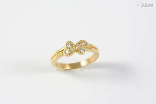 A DIAMOND AND GOLD BUTTERFLY RING BY CARTIER set with circul...