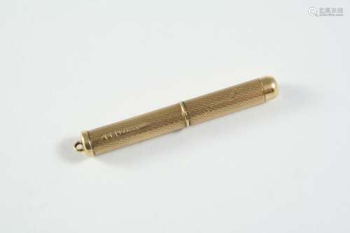 A 9CT GOLD CIGAR CUTTER engraved with engine turned decorati...