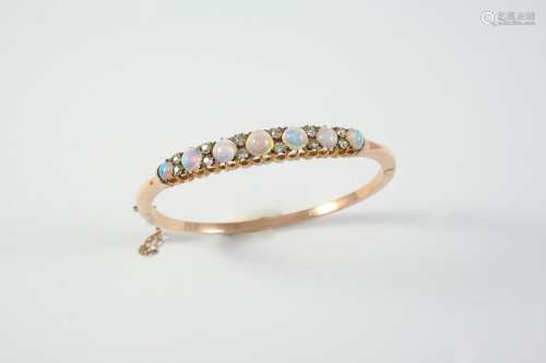 AN EARLY 20TH CENTURY OPAL AND DIAMOND HALF HINGED BANGLE mo...