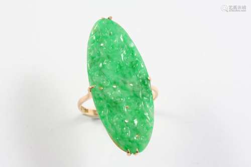 A JADEITE JADE AND GOLD RING mounted with an oval section of...