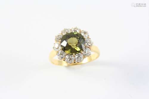 AN ALEXANDRITE AND DIAMOND CLUSTER RING the cushion-shaped a...