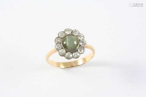 A CHRYSOBERYL CAT'S-EYE AND DIAMOND CLUSTER RING the circula...