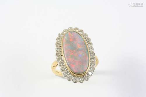 A BLACK OPAL AND DIAMOND CLUSTER RING the oval-shaped solid ...