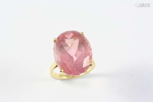 A PINK TOURMALINE SINGLE STONE RING the oval-shaped tourmali...