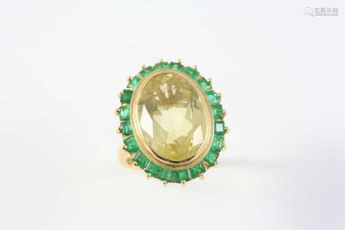 A CITRINE AND EMERALD CLUSTER RING the oval-shaped citrine i...