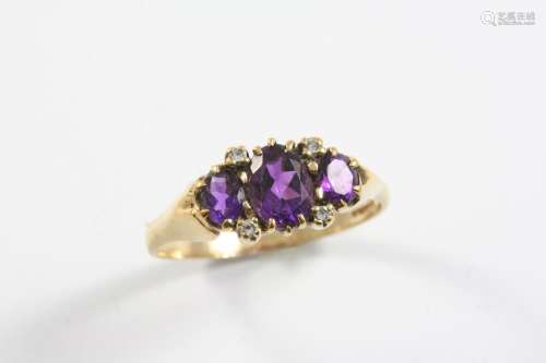 AN AMETHYST AND DIAMOND RING the three graduated oval-shaped...