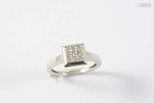 A DIAMOND PLAQUE RING mounted with nine circular-cut diamond...