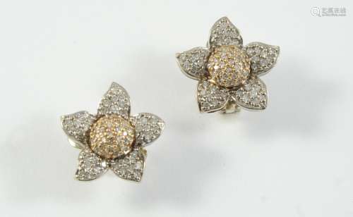 A PAIR OF DIAMOND SET EARRINGS of flowerhead form, each set ...