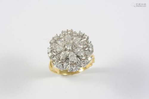 A DIAMOND CLUSTER RING the flowerhead design is centred with...