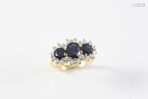 A SAPPHIRE AND DIAMOND TRIPLE CLUSTER RING mounted with an o...
