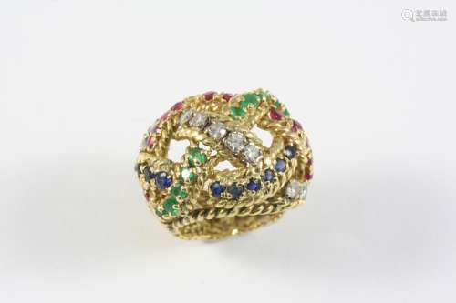 A GOLD AND GEM SET RING the woven openwork design is mounted...