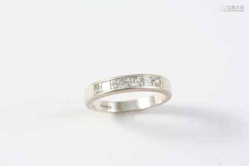 A DIAMOND HALF HOOP RING mounted with seven square-shaped di...