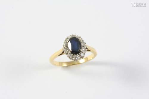 A SAPPHIRE AND DIAMOND CLUSTER RING the oval-shaped sapphire...