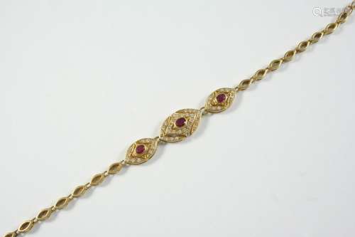A GOLD, RUBY AND DIAMOND BRACELET formed with three navette-...