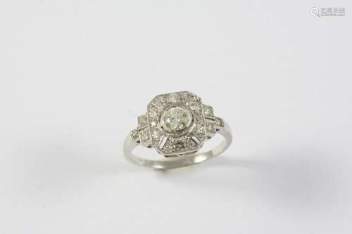 A DIAMOND CLUSTER RING the circular-cut diamond is collet se...