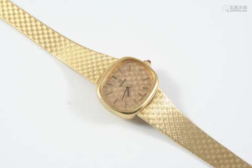 A LADY'S 9CT GOLD WRISTWATCH BY OMEGA the signed oval shaped...