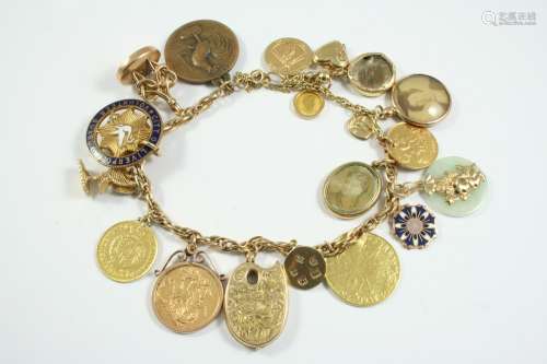 A 9CT GOLD CHARM BRACELET suspending many assorted charms, i...