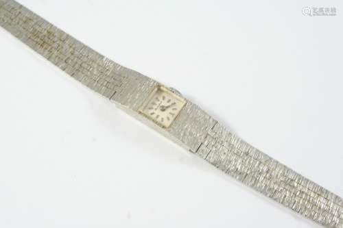 A LADY'S 9CT WHITE GOLD WRISTWATCH BY BUECHE-GIROD the signe...
