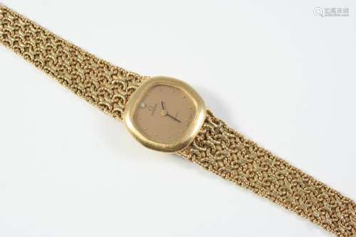 A LADY'S 9CT GOLD WRISTWATCH BY OMEGA the signed cushion-sha...