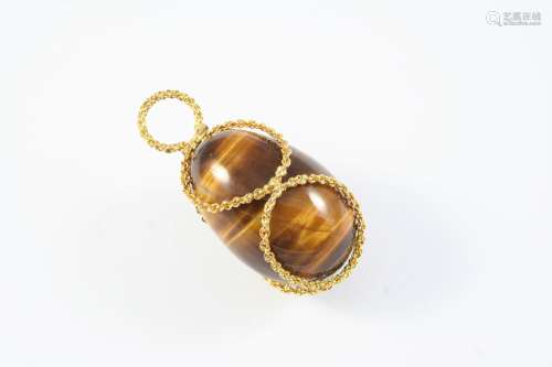 A TIGER'S EYE AND GOLD PENDANT the egg-shaped tiger's eye is...
