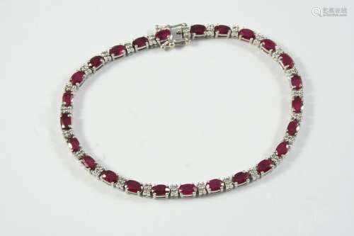 A RUBY AND DIAMOND LINE BRACELET alternately set with oval-s...