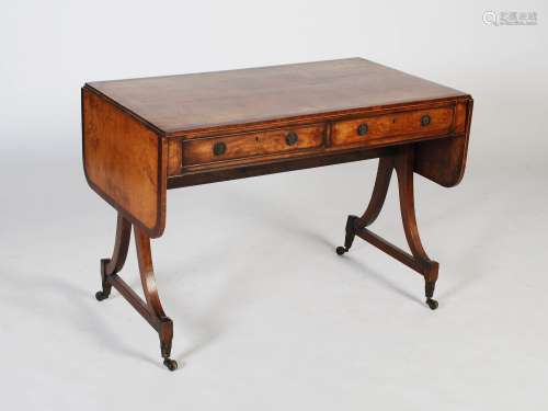 An early 19th century mahogany and rosewood sofa table, the ...