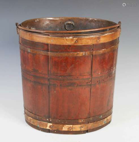 A 19th century mahogany and brass bound oval pail, with hing...