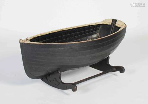 A 19th century child's crib in the form of a clinker-built b...