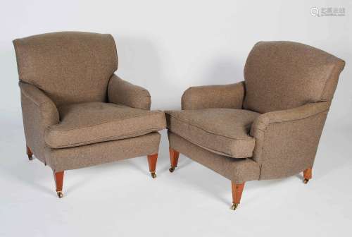 A pair of mahogany club armchairs in the style of Howard & S...