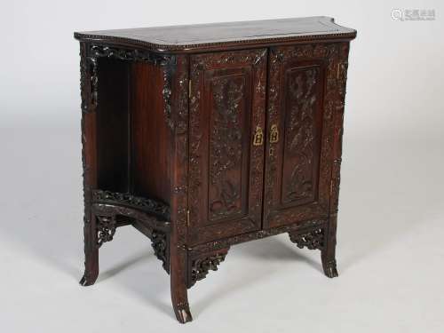 A Chinese dark wood side cabinet, Qing Dynasty, the shaped p...